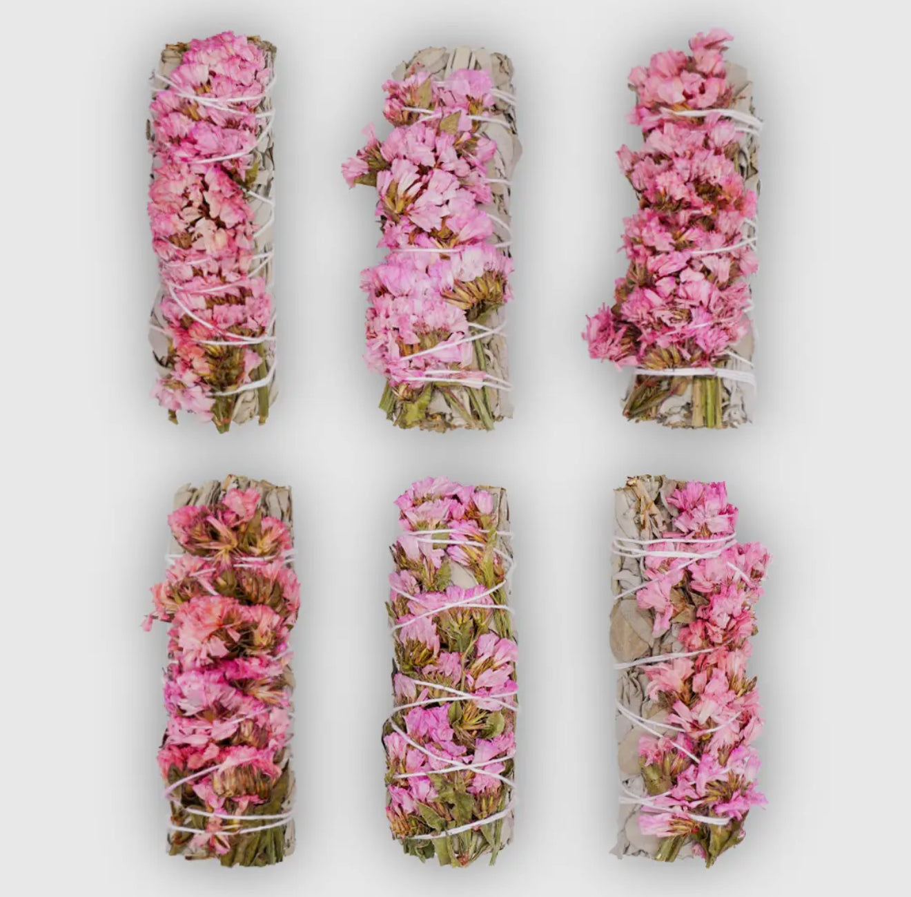 Pink Sinuata flower with white sage smudge stick
