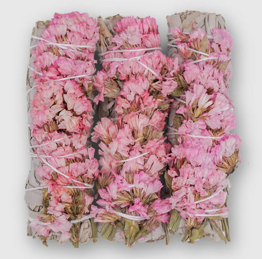 Pink Sinuata flower with white sage smudge stick